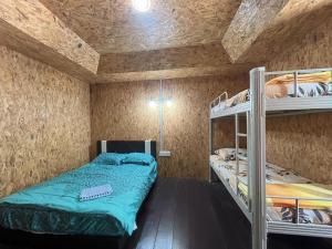 a bedroom with two bunk beds and a ceiling at Bee Chalet Perhentian Island in Perhentian Island