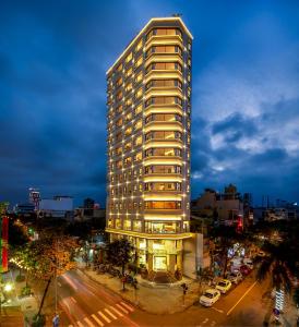a tall building on a city street at night at Val Soleil Hotel in Da Nang