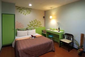 a bedroom with a bed and a desk and a desk at Tong Bing Express in Hsinchu City