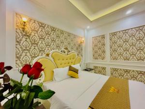a bedroom with a white bed with red roses on it at Diamond Hotel Ha Noi in Hanoi