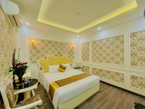 a hotel room with a bed and a table at Diamond Hotel Ha Noi in Hanoi