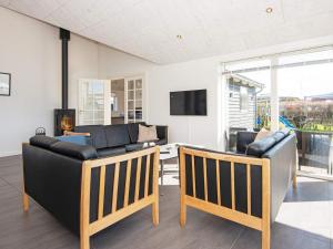a living room with two leather chairs and a couch at Holiday home Vejle in Vejle