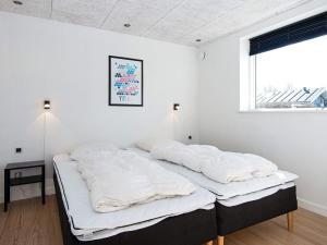 two beds in a room with white walls and a window at Holiday home Vejle in Vejle