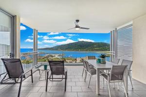 a dining room with a view of the ocean at Sea La Vie in Airlie Beach