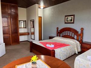 a hotel room with two beds and a table at Chateau Palace in São Lourenço