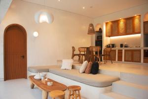 a living room with a couch and a table at Villa Soll B By The Villas 100 in Bogor