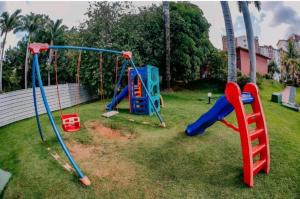 a playground with two swings and a slide at Hot springs - suíte Premium in Caldas Novas