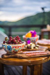a wooden table with two bowls of fruit on it at Valhalla Nimaima Glamping in Nimaima
