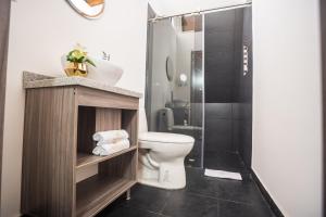 a bathroom with a toilet and a shower at Valhalla Nimaima Glamping in Nimaima +37 photos