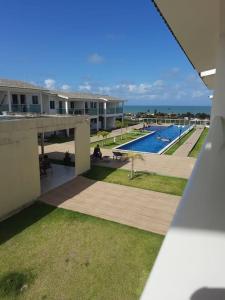 a view of a resort with a swimming pool at Excelente Bangalô/duplex em Jacumã - PB in Conde