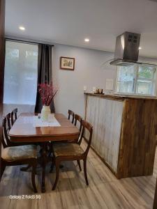 comedor con mesa y sillas y cocina en Stylish Homestay Close CBD en Hamilton