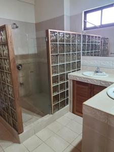 a bathroom with a shower and a sink at Hermosa Beach House in Playa Hermosa