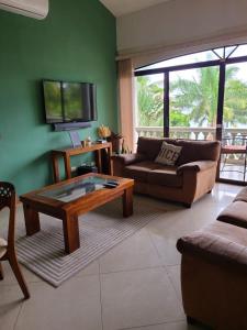 a living room with a couch and a coffee table at Hermosa Beach House in Playa Hermosa