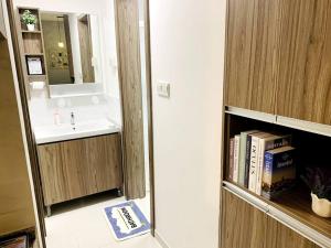 a bathroom with a sink and a mirror and a book shelf at 森林城市 JiaJia Homestay【北欧工业风】@ 免税岛 Legoland JB SG in Gelang Patah