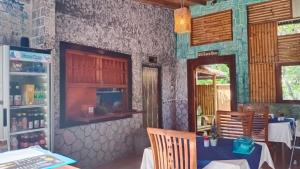 a dining room with a table and a mirror at Gili Guest House in Gili Air