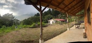 a porch of a house with a view of a mountain at Cabaña Trojas Valverde Vega in Trojas