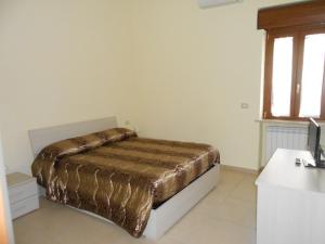 フィウミチーノにあるAppartamento Fiumicinoのベッドルーム1室(金の毛布付きのベッド1台付)