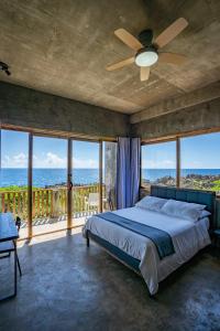 a bedroom with a bed and views of the ocean at Izustarri in Burgos