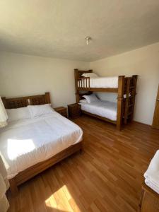 um quarto com 2 beliches e pisos em madeira em Floresta Casa de Campo em Amecameca de Juárez
