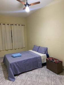 a bedroom with two beds and a ceiling fan at Apartamento em frente Basílica in Aparecida