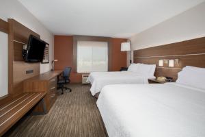 a hotel room with two beds and a flat screen tv at Holiday Inn Express & Suites Tucson, an IHG Hotel in Tucson