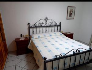 a bedroom with a bed and two night stands at villa PICOZZI cannigione in Cannigione