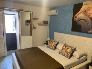 ein Schlafzimmer mit einem Bett und einem Wandgemälde in der Unterkunft Casa Raccuglia in Palermo