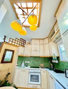 a kitchen with wooden cabinets and a skylight at Villa Zografos in Irakleia +76 photos