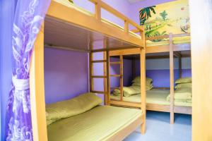 a bunk bed room with three bunk beds in it at SAKURA House - Hoa Ban in Mộc Châu