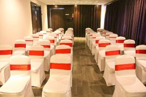 a row of white chairs in a conference room at J Hotel in Port Blair