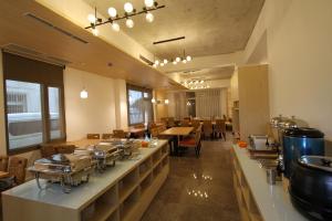 a restaurant with a counter with pots and pans on it at Silia Hostel in Ji'an