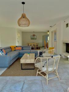 a living room with a blue couch and chairs at Villa Le Thoronet - Piscine Jardin Barbecue Plancha 3 chambres - Nicolas in Le Thoronet