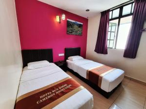 Postel nebo postele na pokoji v ubytování Hotel Sun Birds