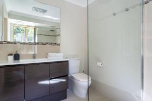 a bathroom with a toilet and a glass shower at Mansfield Retreat - In Town - Margaret River in Margaret River Town +27 photos