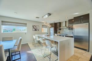 a kitchen with a large island with chairs and a table at Amazing Location! Old Town Scottsdale Modern Home in Scottsdale