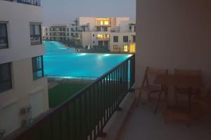 a view of a swimming pool from a apartment balcony at Lovely 3-bedroom vacation home -Marassi in Alexandria