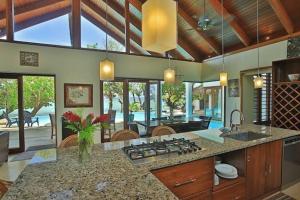 a kitchen with a counter with a stove top oven at The Jewel of The Coral Coast in Tangangge
