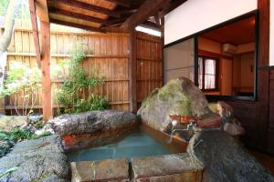 a pond in the middle of a house at YamakawaZENZO in Oguni