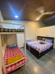 a bedroom with two bunk beds and a ceiling at Green Fog Guesthouse in Lonavala