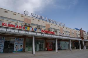 um grande edifício com uma placa em cima em Xabib&son's hotel em Bukhara