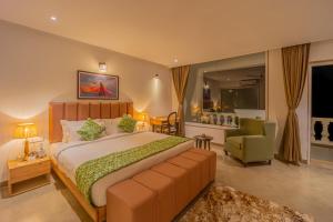 a bedroom with a large bed and a couch at Tree of Life Vantara Resort & Spa in Udaipur