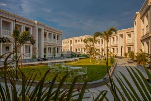a courtyard of a building with tables and chairs at Tree of Life Vantara Resort & Spa in Udaipur