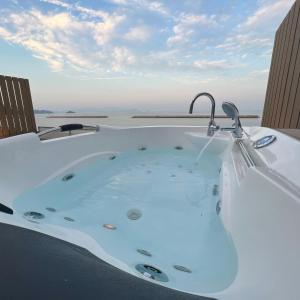 a jacuzzi tub on the roof of a house at Beach SPA TSUDA 1 Uno in Sanuki