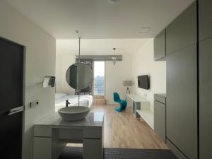 a bathroom with a sink and a bed and a mirror at Hotel Praha Liberec in Liberec +37 photos