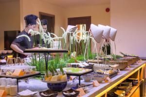 a buffet of food on a long table at The Glomad Danang Hotel in Da Nang