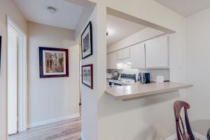 a kitchen with white cabinets and a counter top at The Heart of Mission Valley in San Diego