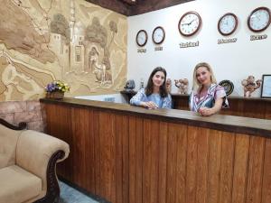 two women sitting at a bar in a waiting room at Pan Asiat in Tashkent