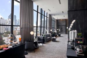 a hotel lobby with a view of a city at Ascott Embassy Sathorn Bangkok in Bangkok