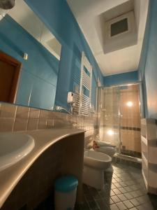 a bathroom with a sink and a toilet and a mirror at La piccola terrazza in Bari