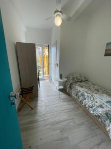 a bedroom with a bed and a table in a room at Hotel Deutsche Familien in Finale Ligure